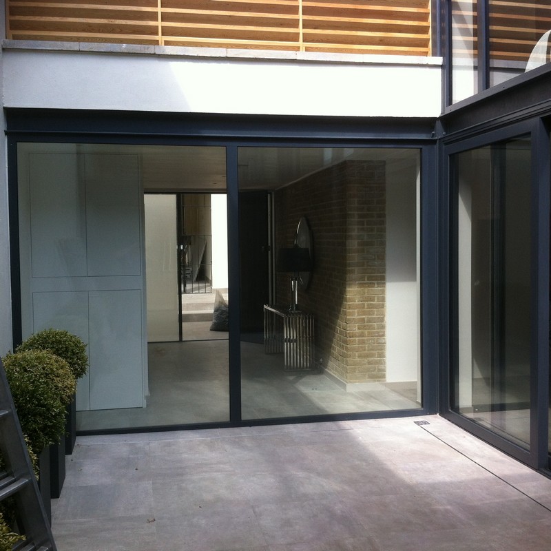 Floor-to-ceiling sliding doors opening to courtyard in Lewisham