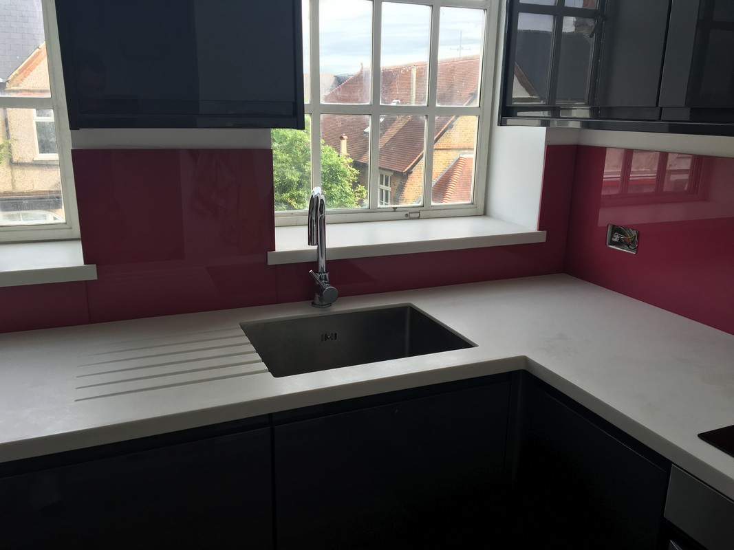 Deep plum coloured glass splashback in modern Lewisham kitchen